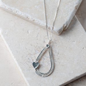 Charming sterling silver necklace with a large teardrop and heart pendant