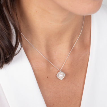 Necklace featuring a single freshwater pearl cradled within a sleek, square sterling silver frame.